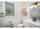 Bright bathroom featuring a white vanity, modern fixtures, and a window offering outdoor views at 621 Bristol Dr, Statesville, NC 28677