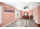 Bedroom with peach colored walls, ceiling fan, wood floors and lots of natural light at 621 Bristol Dr, Statesville, NC 28677