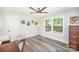 Bright bedroom with hardwood floors, a ceiling fan, and natural light from the windows at 621 Bristol Dr, Statesville, NC 28677