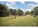 A spacious lot featuring a shed, detached garage, multiple parking spots, and lush greenery at 621 Bristol Dr, Statesville, NC 28677