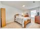 Bright bedroom featuring carpet, white walls, and natural wood furnishings, dresser and decor at 634 Gants Rd, York, SC 29745