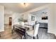 Bright dining room featuring wood floors adjacent to the staircase, living room, and kitchen at 634 Gants Rd, York, SC 29745