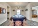 Stylish game room featuring a pool table under a modern chandelier, and dark hardwood floors at 634 Gants Rd, York, SC 29745