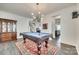 Elegant game room features a pool table, a modern chandelier, and dark hardwood floors at 634 Gants Rd, York, SC 29745