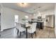 Open concept kitchen and dining area with stainless steel appliances and a modern kitchen island at 634 Gants Rd, York, SC 29745