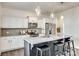 Spacious kitchen with white cabinets, stainless steel appliances, granite countertops and three stools at 634 Gants Rd, York, SC 29745