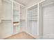 Spacious walk-in closet with ample shelving and custom organization system and neutral carpet at 634 Gants Rd, York, SC 29745