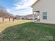 Expansive backyard featuring a well-manicured lawn and a view of neighboring homes at 8418 Loxton Cir, Charlotte, NC 28214