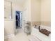 Main bathroom featuring tile floors, a bathtub, a walk-in shower, granite countertops, and a walk-in closet at 8418 Loxton Cir, Charlotte, NC 28214