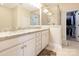 Main bathroom featuring granite countertops, double vanity, a walk-in shower with glass door and a walk-in closet at 8418 Loxton Cir, Charlotte, NC 28214