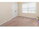 Bedroom featuring neutral walls, plush carpet, natural light and a spacious closet at 8418 Loxton Cir, Charlotte, NC 28214