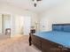 Bedroom featuring neutral walls, plush carpet, and an ensuite bathroom and closet at 8418 Loxton Cir, Charlotte, NC 28214