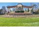 Community entrance featuring stone structures and meticulous landscaping at 8418 Loxton Cir, Charlotte, NC 28214