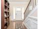 Inviting foyer with hardwood floors, staircase, and a stylish decorative rug at 8418 Loxton Cir, Charlotte, NC 28214