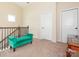 Hallway features a green bench, neutral carpet, and ample natural light at 8418 Loxton Cir, Charlotte, NC 28214