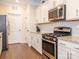 Kitchen featuring stainless steel appliances, granite countertops, white cabinets, and a stylish subway tile backsplash at 8418 Loxton Cir, Charlotte, NC 28214