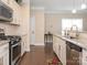 Kitchen featuring stainless steel appliances, granite countertops, white cabinets, and a stylish subway tile backsplash at 8418 Loxton Cir, Charlotte, NC 28214