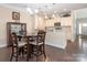 Eat-in kitchen features white cabinets, granite countertops, pendant lighting, and stainless steel appliances at 8418 Loxton Cir, Charlotte, NC 28214