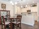 Eat-in kitchen with a dark wood table, bar seating, granite countertops, and stainless steel appliances at 8418 Loxton Cir, Charlotte, NC 28214