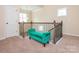 Upstairs landing area featuring plush carpet, decorative railing, and bright window at 8418 Loxton Cir, Charlotte, NC 28214