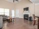 Bright living room features high ceilings, hardwood floors, a fireplace, and access to the outdoors at 8418 Loxton Cir, Charlotte, NC 28214
