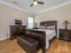 Main bedroom featuring hardwood floors, a ceiling fan, a queen bed and matching wood furniture at 8418 Loxton Cir, Charlotte, NC 28214