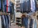 Organized walk-in closet featuring built-in shelving, drawers, and hanging rods for optimal storage at 8418 Loxton Cir, Charlotte, NC 28214