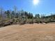 Spacious backyard featuring a large, grassy area and mature trees at 9432 Liberty Hill Dr, Mint Hill, NC 28227