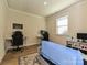 Comfortable bedroom featuring a couch, desk with gaming chairs, and ample natural light at 9432 Liberty Hill Dr, Mint Hill, NC 28227
