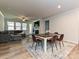 Dining area with a wooden table, chairs, area rug, and a view of the living room with a fireplace at 9432 Liberty Hill Dr, Mint Hill, NC 28227