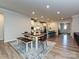 Dining area with wooden table and bench seating adjacent to a modern kitchen with granite countertops at 9432 Liberty Hill Dr, Mint Hill, NC 28227