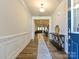 Bright entryway with hardwood floors, decorative molding, console table, and an open view to the living spaces at 9432 Liberty Hill Dr, Mint Hill, NC 28227