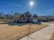 Charming single-story brick home featuring an attached garage, manicured lawn, and inviting front porch at 9432 Liberty Hill Dr, Mint Hill, NC 28227