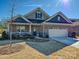 Charming single-Gathering home with a brick facade, covered porch, well-manicured lawn, and two-car garage at 9432 Liberty Hill Dr, Mint Hill, NC 28227