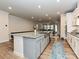 Open concept: Kitchen with island flowing into dining and living areas, perfect for entertaining guests at 9432 Liberty Hill Dr, Mint Hill, NC 28227