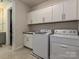 Convenient laundry room with washer, dryer, sink, and cabinets for storage, making laundry a breeze at 9432 Liberty Hill Dr, Mint Hill, NC 28227