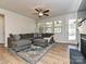 Spacious living room with a sectional sofa, hardwood floors, fireplace, and a view of the backyard at 9432 Liberty Hill Dr, Mint Hill, NC 28227
