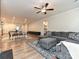 Open-concept living space with a large sectional, area rug, hardwood floors, dining table, and kitchen view at 9432 Liberty Hill Dr, Mint Hill, NC 28227