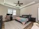 Relaxing main bedroom featuring a ceiling fan, wood floors, neutral colors, and space for a desk at 9432 Liberty Hill Dr, Mint Hill, NC 28227