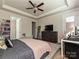 Large main bedroom with wood floors, ceiling fan, and access to an ensuite bathroom and walk-in closet at 9432 Liberty Hill Dr, Mint Hill, NC 28227