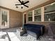 Covered patio with a comfortable seating area and ceiling fan at 9432 Liberty Hill Dr, Mint Hill, NC 28227