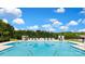 Outdoor community swimming pool featuring comfortable lounge chairs and shady umbrellas at 9432 Liberty Hill Dr, Mint Hill, NC 28227