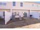Back of house showing a small patio, grill, grass and partial fencing at 10316 Stineway Ct, Pineville, NC 28134