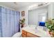 Bright bathroom featuring a vanity sink and tiled shower, enhanced with fresh greenery at 10316 Stineway Ct, Pineville, NC 28134