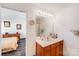 Clean bathroom features a vanity with a large mirror and good lighting, next to the bedroom at 10316 Stineway Ct, Pineville, NC 28134