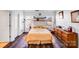Inviting bedroom with dark wood floors, large windows, and ample natural light at 10316 Stineway Ct, Pineville, NC 28134