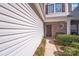 Close-up view of the home's entrance showcasing the front door and manicured shrubbery at 10316 Stineway Ct, Pineville, NC 28134
