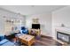 Cozy living room with a fireplace, dark wood floors, and ample natural light at 10316 Stineway Ct, Pineville, NC 28134