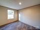 Bedroom featuring neutral walls, durable floors, and natural light from a large window at 1085 Cedar Hill Dr, Rockwell, NC 28138