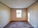 Bedroom featuring neutral walls, durable floors, and natural light from a large window at 1085 Cedar Hill Dr, Rockwell, NC 28138